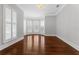 Elegant living room with hardwood floors, natural light, and decorative shutters on bay windows at 1251 Aquila Loop, Celebration, FL 34747