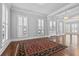 Bright living room featuring hardwood floors, elegant shutters, and decorative columns at 1251 Aquila Loop, Celebration, FL 34747