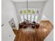 Aerial view of the living room showcasing hardwood floors and a large picture window at 1251 Aquila Loop, Celebration, FL 34747