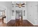 Spacious living room with hardwood floors, a staircase, and a kitchen entry, ideal for entertaining at 1251 Aquila Loop, Celebration, FL 34747