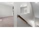 Loft area with neutral paint and carpet, featuring railing and staircase at 1251 Aquila Loop, Celebration, FL 34747