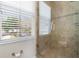 Walk-in shower featuring glass door and tile surround, next to bathroom window at 1251 Aquila Loop, Celebration, FL 34747