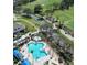 Aerial view of the community pool, clubhouse, and golf course at 1336 Lattimore Dr, Clermont, FL 34711