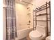 Cozy bathroom featuring a shower/tub combination, tile floors, and storage shelves at 1336 Lattimore Dr, Clermont, FL 34711