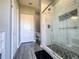 Tastefully remodeled bathroom featuring a tiled walk-in shower, wood-look flooring and modern fixtures at 1336 Lattimore Dr, Clermont, FL 34711