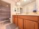 Bathroom featuring a double sink vanity with wood cabinets and a shower/tub combo at 1336 Lattimore Dr, Clermont, FL 34711