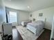 A bright bedroom with two twin beds, hardwood floors, and soft, neutral decor at 1336 Lattimore Dr, Clermont, FL 34711