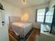 Cozy bedroom with a neutral color scheme, hardwood floors, and natural light from the window at 1336 Lattimore Dr, Clermont, FL 34711