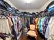 Large walk-in closet provides ample space for storage and organization, complete with a comfortable chair at 1336 Lattimore Dr, Clermont, FL 34711