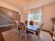 An elegant dining room features a chandelier, dining table, and view of staircase at 1336 Lattimore Dr, Clermont, FL 34711