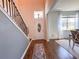 Inviting foyer with wood floors, a staircase, and a front door with decorative glass at 1336 Lattimore Dr, Clermont, FL 34711