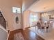Welcoming foyer featuring wood floors, stairs, and a bright dining area with chandelier at 1336 Lattimore Dr, Clermont, FL 34711