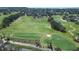 Scenic aerial view of the expansive golf course with lush fairways and trees in the community at 1336 Lattimore Dr, Clermont, FL 34711