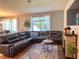 Inviting living room with a large sectional sofa, fireplace, and natural light at 1336 Lattimore Dr, Clermont, FL 34711