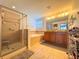 Main bathroom featuring a glass enclosed shower, large soaking tub, and a double sink vanity at 1336 Lattimore Dr, Clermont, FL 34711