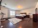 Bright main bedroom featuring wood floors, a large bed, a window, and neutral decor at 1336 Lattimore Dr, Clermont, FL 34711