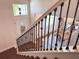 Elegant staircase with decorative wrought iron spindles, with entry and dining visible below at 1336 Lattimore Dr, Clermont, FL 34711