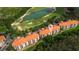Aerial view of the condo complex showcases its proximity to a golf course and lush greenery at 1370 Tuscana Ln # 5406, Davenport, FL 33896