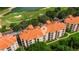 Beautiful aerial view of the condo complex overlooking a lush green golf course and serene lake at 1370 Tuscana Ln # 5406, Davenport, FL 33896
