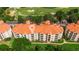 Aerial view showcases the condo building with a golf course, parking, and well-maintained landscaping at 1370 Tuscana Ln # 5406, Davenport, FL 33896