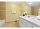 Bright bathroom featuring double vanity, large mirror, and neutral color scheme at 1370 Tuscana Ln # 5406, Davenport, FL 33896
