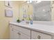 Bright bathroom featuring white cabinets, a shower with glass doors, and attractive nautical-themed decorations at 1370 Tuscana Ln # 5406, Davenport, FL 33896