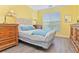 Charming bedroom featuring a comfortable bed, bedside tables, and a sunlit window at 1370 Tuscana Ln # 5406, Davenport, FL 33896