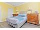 Well-lit bedroom featuring a plush bed, soft lighting, and classic wooden furniture at 1370 Tuscana Ln # 5406, Davenport, FL 33896