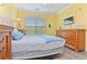 Bright bedroom featuring a soft comfortable bed, complemented by natural light and classic wooden furniture at 1370 Tuscana Ln # 5406, Davenport, FL 33896