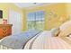 Serene bedroom with a soft color palette, complemented by natural light and a view of the outdoors at 1370 Tuscana Ln # 5406, Davenport, FL 33896