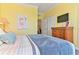 Comfortable bedroom with soft color palette, complemented by natural light and classic wooden furniture at 1370 Tuscana Ln # 5406, Davenport, FL 33896