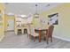Bright dining room with modern lighting, seating for four, and adjacent white kitchen at 1370 Tuscana Ln # 5406, Davenport, FL 33896