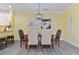 Well-lit dining area with seating for six, stylish decor, and easy access to the kitchen at 1370 Tuscana Ln # 5406, Davenport, FL 33896