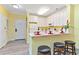 Modern kitchen and dining bar with white cabinets, and breakfast bar seating at 1370 Tuscana Ln # 5406, Davenport, FL 33896