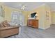 Cozy living room featuring a comfortable sofa, entertainment center, and balcony access at 1370 Tuscana Ln # 5406, Davenport, FL 33896
