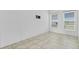 This bedroom features tile floors and two windows for natural light at 139 Columbia Dr, Poinciana, FL 34759