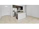 Modern kitchen featuring stainless steel appliances, dark cabinetry, and a center island with a sink at 139 Columbia Dr, Poinciana, FL 34759