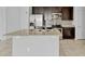 Stylish kitchen with a center island, granite countertops, dark cabinets, and stainless steel appliances at 139 Columbia Dr, Poinciana, FL 34759