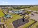 Aerial view of the community playground, pool and clubhouse surrounded by palm trees at 1431 Lassen St, Haines City, FL 33844