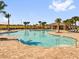 Large community pool featuring plenty of lounge chairs, shaded tables and manicured palm trees at 1431 Lassen St, Haines City, FL 33844
