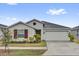 Charming single-story home with manicured landscaping, attached garage, and neutral color scheme at 1431 Lassen St, Haines City, FL 33844