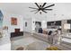 Open-concept living room with stylish decor, fan, and seamless flow into kitchen at 1431 Lassen St, Haines City, FL 33844