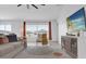 Bright living room with neutral paint, modern furnishings, and large windows offering neighborhood views at 1431 Lassen St, Haines City, FL 33844