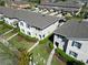 Aerial view of the neighborhood featuring well-maintained townhomes, landscaping, and inviting green spaces at 1615 Reflection Cv, St Cloud, FL 34771