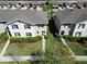 Aerial view of townhomes showcasing well-maintained landscaping, lush lawns, and inviting curb appeal at 1615 Reflection Cv, St Cloud, FL 34771