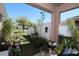 Backyard featuring a covered patio and a variety of potted plants creating a lush outdoor retreat at 1615 Reflection Cv, St Cloud, FL 34771