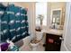 Functional bathroom featuring a vanity with dark cabinets and a toilet, decorated with sports team decor at 1615 Reflection Cv, St Cloud, FL 34771