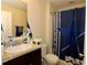 Bathroom with a single sink, a toilet, and a blue star shower curtain at 1615 Reflection Cv, St Cloud, FL 34771