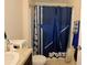 Bathroom with a single sink, toilet, and blue shower curtain at 1615 Reflection Cv, St Cloud, FL 34771