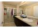 Bathroom with double sinks, large mirror, and walk-in shower with a glass door at 1615 Reflection Cv, St Cloud, FL 34771